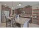 Spacious kitchen with granite countertops, stainless steel appliances, and dark wood cabinetry at 16763 W Adams St, Goodyear, AZ 85338