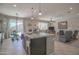 Open-concept kitchen with an island and seamless flow into the living area and backyard at 16763 W Adams St, Goodyear, AZ 85338