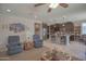 Open-concept living area flowing into a modern kitchen with granite counters and stainless appliances at 16763 W Adams St, Goodyear, AZ 85338