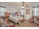 Comfortable main bedroom with large windows, ceiling fan, and hardwood floors offering a tranquil space at 16763 W Adams St, Goodyear, AZ 85338