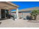 Covered patio features a built-in outdoor kitchen with a grill, perfect for entertaining, alongside a cozy seating area at 16763 W Adams St, Goodyear, AZ 85338