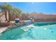 Inviting backyard pool with a beautiful waterfall feature and desert landscaping at 16763 W Adams St, Goodyear, AZ 85338