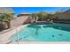 Swimming pool with a waterfall feature and mature landscaping at 16763 W Adams St, Goodyear, AZ 85338