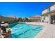 Backyard features a sparkling pool with manicured landscaping at 16763 W Adams St, Goodyear, AZ 85338