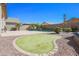 Manicured backyard features a pristine putting green, ideal for golf enthusiasts, along with a refreshing pool at 16763 W Adams St, Goodyear, AZ 85338