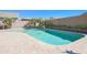 Sparkling swimming pool with a soothing waterfall feature, surrounded by lush landscaping and a spacious patio area at 16763 W Adams St, Goodyear, AZ 85338