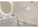 Bathroom boasts walk-in shower, modern vanity, and backlit mirror at 18211 N 24Th Ave, Phoenix, AZ 85023