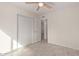 Bedroom features a ceiling fan, closet, wood-look tile flooring and a neutral color palette at 18211 N 24Th Ave, Phoenix, AZ 85023