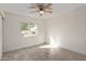 Bright bedroom with wood-look tile flooring and a sun-drenched window at 18211 N 24Th Ave, Phoenix, AZ 85023