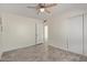 Bright bedroom features a ceiling fan, tile flooring, and a sliding closet door at 18211 N 24Th Ave, Phoenix, AZ 85023