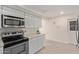 Modern kitchen with stainless steel appliances, light-colored cabinets, and stylish countertops at 18211 N 24Th Ave, Phoenix, AZ 85023