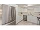Stylish kitchen featuring stainless steel appliances, white cabinets, and modern tile flooring at 18211 N 24Th Ave, Phoenix, AZ 85023