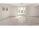 Bright living room boasts a window seat, light gray wood-look tile floors, and neutral paint at 18211 N 24Th Ave, Phoenix, AZ 85023