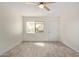 Cozy living room featuring neutral paint, light-colored tile floors and a ceiling fan with light at 18211 N 24Th Ave, Phoenix, AZ 85023