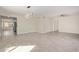 Spacious living room featuring modern light fixture, neutral paint, and wood-look tile flooring at 18211 N 24Th Ave, Phoenix, AZ 85023