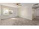 Inviting living room featuring tile flooring, a ceiling fan, and a bright front-facing window at 18211 N 24Th Ave, Phoenix, AZ 85023
