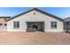 Backyard featuring a hot tub, a covered patio, and rock landscaping at 18369 W La Senda Dr, Surprise, AZ 85387