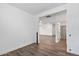 A bright room features wood-look floors, white walls and leads to other rooms at 18369 W La Senda Dr, Surprise, AZ 85387