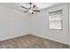 Bright bedroom with a ceiling fan and a window with blinds at 18369 W La Senda Dr, Surprise, AZ 85387