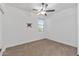 Cozy bedroom with plush carpet and a ceiling fan at 18369 W La Senda Dr, Surprise, AZ 85387