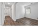 An interior view of a bedroom featuring wood floors, a window with blinds, and white walls at 18369 W La Senda Dr, Surprise, AZ 85387