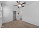 Bedroom featuring plush carpet, ceiling fan, and a closet at 18369 W La Senda Dr, Surprise, AZ 85387