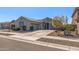 Beautiful home with three-car garage, desert landscaping, and a welcoming facade under a clear blue sky at 18369 W La Senda Dr, Surprise, AZ 85387