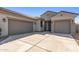 Lovely home features a three-car garage, desert landscaping, and a charming facade perfect for suburban living at 18369 W La Senda Dr, Surprise, AZ 85387