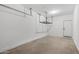 Garage featuring concrete floor and overhead storage rack at 18369 W La Senda Dr, Surprise, AZ 85387