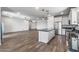 Modern white kitchen with an island open to the living room at 18369 W La Senda Dr, Surprise, AZ 85387