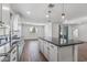 Bright kitchen features a large island, stainless steel sink, and wood-look floors, perfect for cooking and entertaining at 18369 W La Senda Dr, Surprise, AZ 85387
