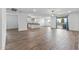 Open-concept living room featuring wood-look tile flooring and sliding glass doors to backyard at 18369 W La Senda Dr, Surprise, AZ 85387