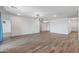Open living room area with wood-look flooring and a ceiling fan at 18369 W La Senda Dr, Surprise, AZ 85387