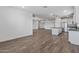 Spacious living room area flowing into the kitchen with a large center island at 18369 W La Senda Dr, Surprise, AZ 85387