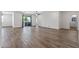 Spacious living room featuring wood-look tile flooring and sliding glass doors at 18369 W La Senda Dr, Surprise, AZ 85387