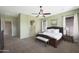 Main bedroom with natural light, a ceiling fan, and an en suite bathroom at 19423 W Oregon Ave, Litchfield Park, AZ 85340