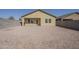 Low-maintenance backyard with gravel, offering a blank canvas for personalization and outdoor living at 19437 W Elm St, Litchfield Park, AZ 85340