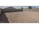 Spacious backyard featuring low maintenance gravel and a tall block wall for privacy at 19437 W Elm St, Litchfield Park, AZ 85340