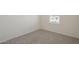 Bedroom featuring neutral carpet, fresh paint, baseboard trim, and a window with blinds at 19437 W Elm St, Litchfield Park, AZ 85340