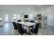 Stylish dining area features modern lighting, white countertops and seating for Gathering and friends at 19437 W Elm St, Litchfield Park, AZ 85340