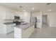 Open kitchen featuring stainless steel appliances, granite countertops, and a functional center island at 19437 W Elm St, Litchfield Park, AZ 85340