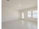 Open living room with tile flooring, a door to the backyard, and windows with blinds at 19437 W Elm St, Litchfield Park, AZ 85340