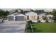 Stunning exterior of a modern farmhouse-style home with a three-car garage and beautiful landscaping at 20255 W Highland Ave, Litchfield Park, AZ 85340