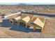 An aerial view displays a newly built home framed with wood, situated on a spacious lot with mountain views at 20255 W Highland Ave, Litchfield Park, AZ 85340