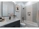A well lit bathroom features modern vanity, black hardware, decorative backsplash in the shower and stylish decor at 20256 W Highland Ave, Litchfield Park, AZ 85340