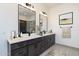 Bright bathroom features double vanity with quartz countertop and modern fixtures with decorative wall art above towel bar at 20256 W Highland Ave, Litchfield Park, AZ 85340
