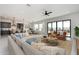 An open-concept living area showcases a modern sofa and smooth floor, with seamless access to the kitchen and dining spaces at 20256 W Highland Ave, Litchfield Park, AZ 85340