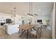Open-concept dining area with modern lighting, stylish seating, and seamless flow to the living space at 20277 W Highland Ave, Litchfield Park, AZ 85340