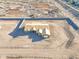 Aerial view shows new home construction, framing and partial lot wall, desert landscape at 20277 W Highland Ave, Litchfield Park, AZ 85340
