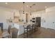 Bright kitchen with white cabinets, a large island, pendant lighting, and stainless steel appliances at 20277 W Highland Ave, Litchfield Park, AZ 85340